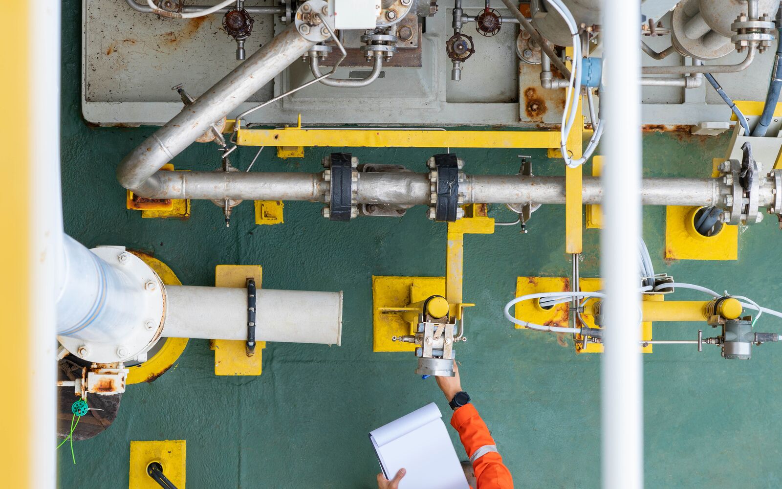 Mechanical operator checking centrifugal pump condition for daily checking oil pump system to maintain reliability of oil and gas production process.